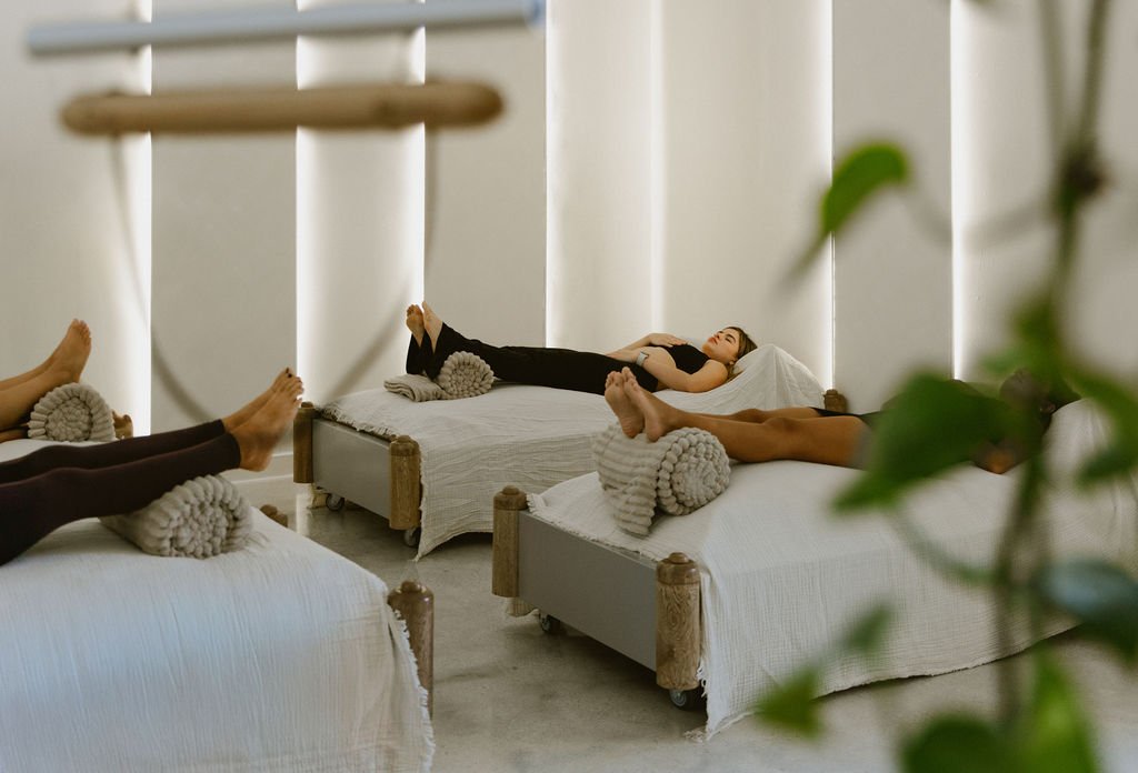 Guests lying on waterbeds during a sound bath
